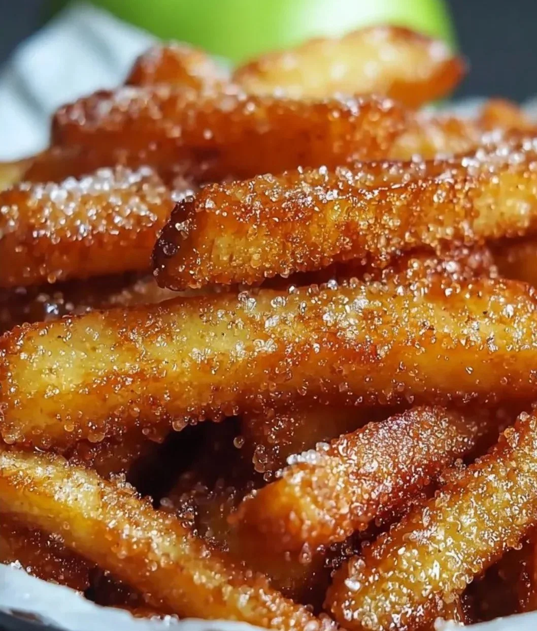 Crispy air fryer apple fries served on a plate with cinnamon dip