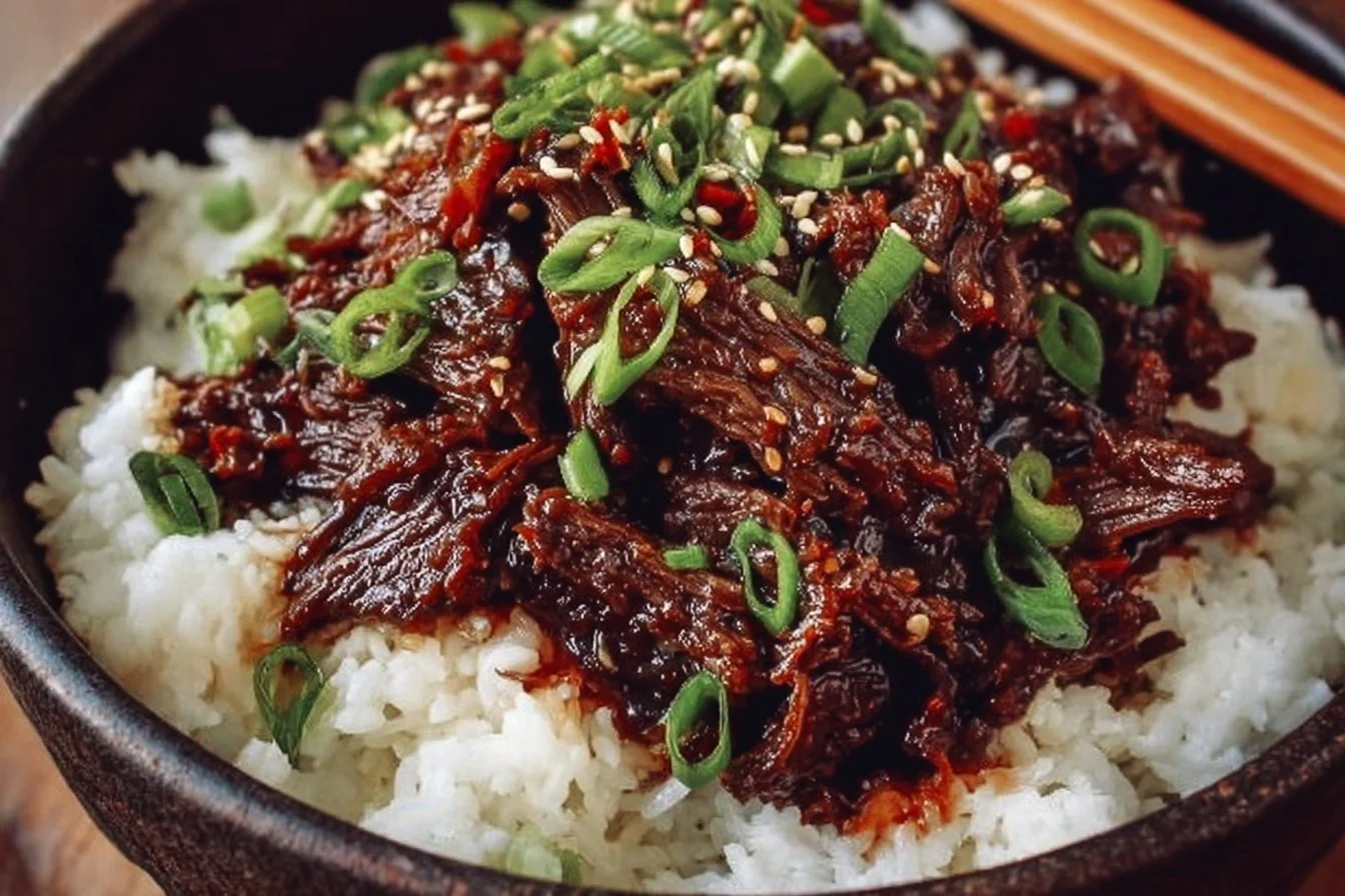 Delicious Slow Cooker Korean Beef served with rice and vegetables