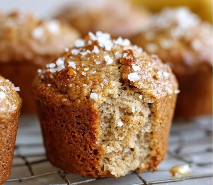 Freshly baked brown butter banana muffins on a cooling rack.