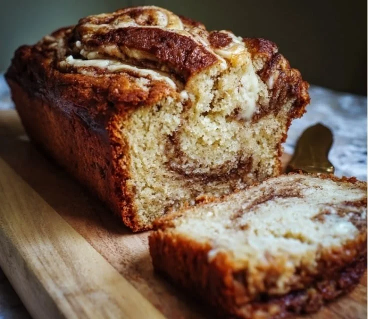 Moist cinnamon roll banana bread topped with sweet cinnamon glaze