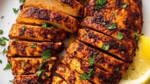 Air Fryer Cajun Chicken served on a plate with spices and vegetables