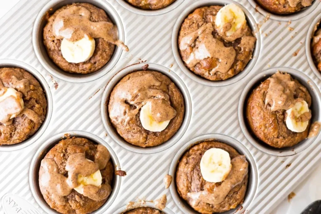 Banana protein muffins stacked on a plate, showcasing their moist texture and natural ingredients.