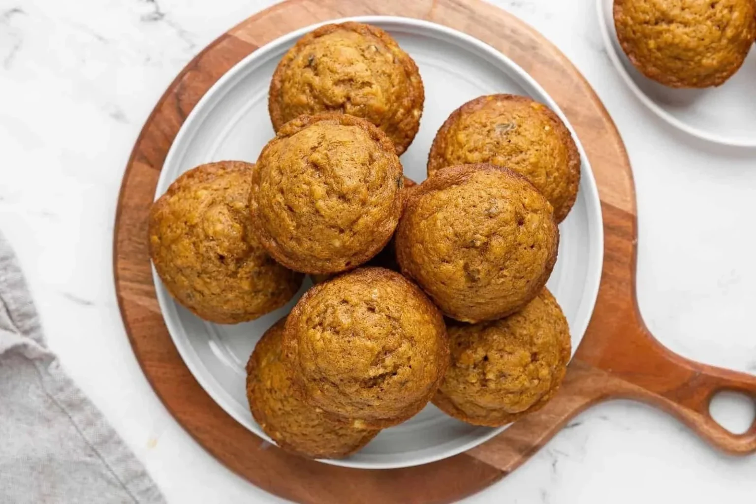 Delicious homemade Pumpkin Banana Muffins cooling on a rack.