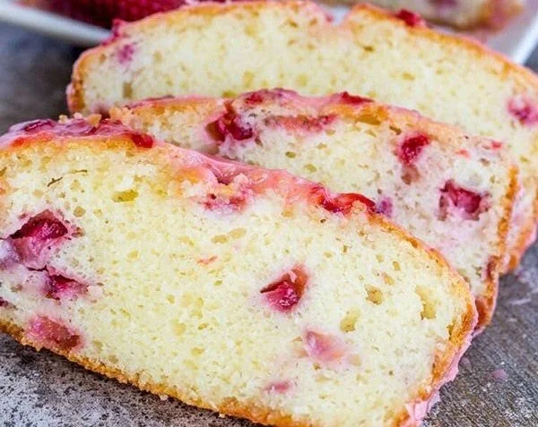 Delicious slice of strawberry pound cake with fresh strawberries on top