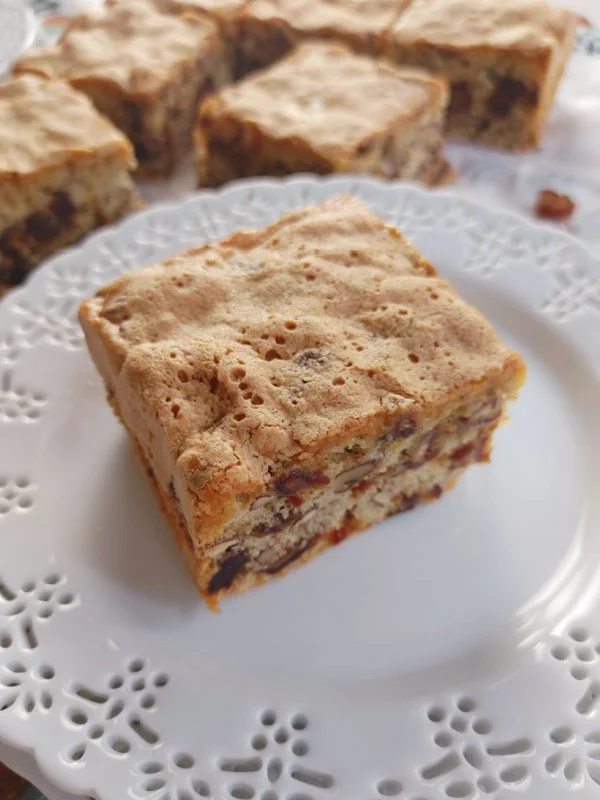 Delicious Date-Nut Snack Cake with nuts and dates on a plate.