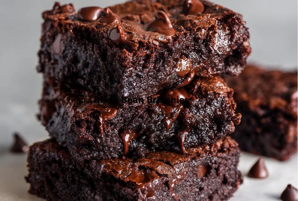 Fudgy black bean brownies on a plate with a drizzle of chocolate sauce
